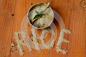 Rice in vintage bowl with vintage teaspoon on wooden background, reis, arroz, riso, riz, Ñ€Ð¸Ñ.